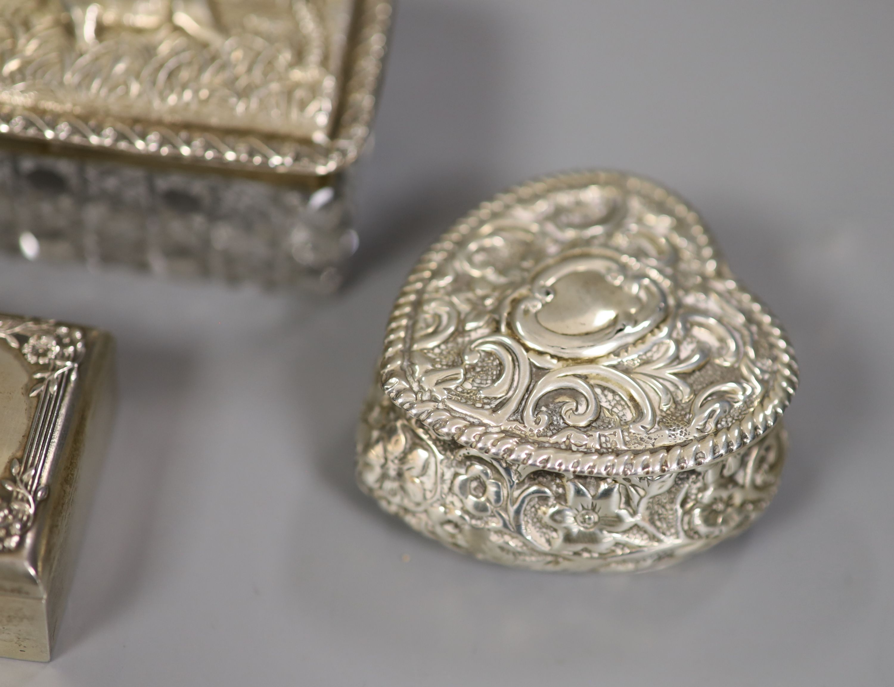 Two Victorian/Edwardian silver heart shaped pill boxes (one with holes), a rectangular snuff box and a toilet box.